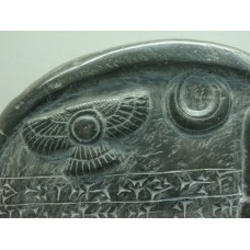Winged disc and a crescent on a stone